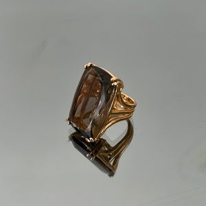 Made in Brazil this costume jewelry ring has a clear gemstone set in gold
